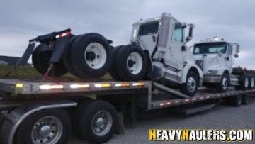 Loading two International daycab trucks on a trailer.